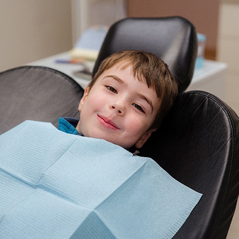 Happy young boy in dental treatment chair