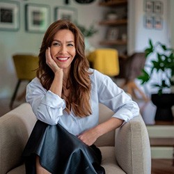Confident, beautiful woman sitting in comfortable chair