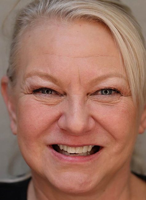 Portrait of happy female patient at Landmark Dental Studio after treatment