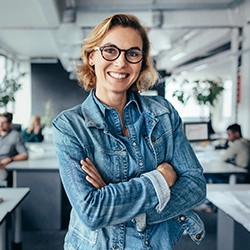 Younger professional smiling while in the office