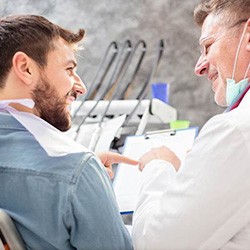 Patient in Greenwood Village talking to dentist about dental implants