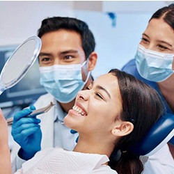 Patient in Greenwood Village smiling with dental implants