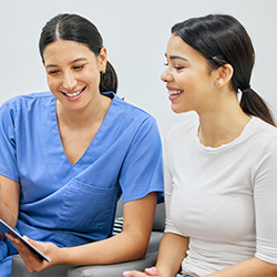 Dental team member and patient looking at clipboard