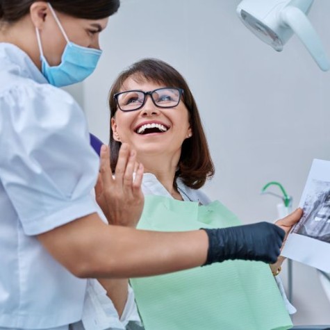 Patient and dental team member looking at X-ray
