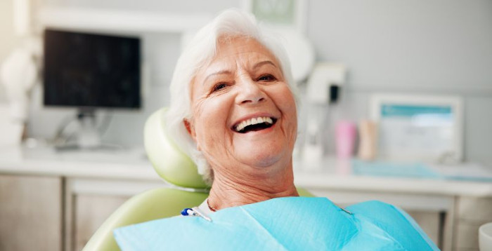 Happy senior patient in dental treatment chair