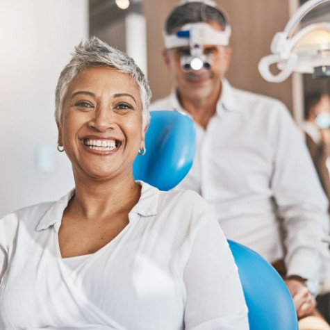 Happy senior patient in dental treatment chair