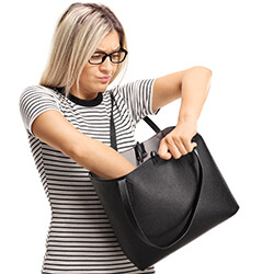 Concerned woman searching her purse for lost item