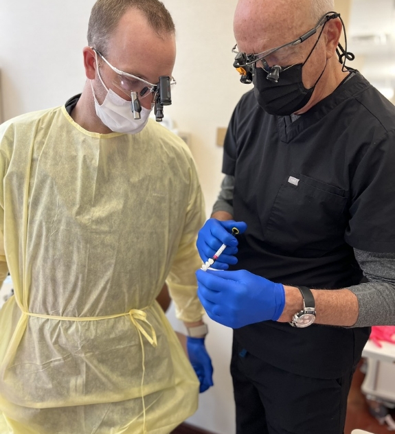 Dr. Mickle showing model of teeth to patient
