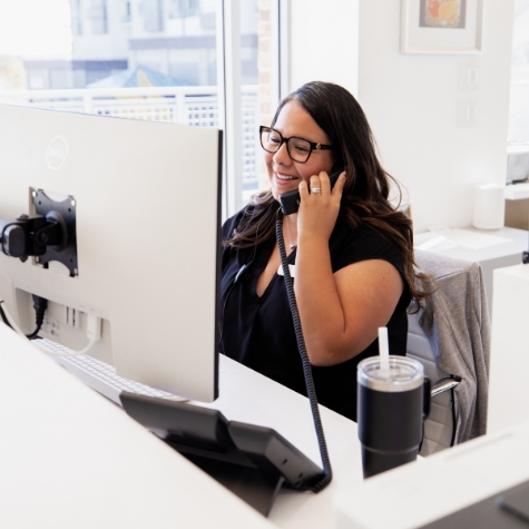 Emergency dentist standing over patient performing treatment