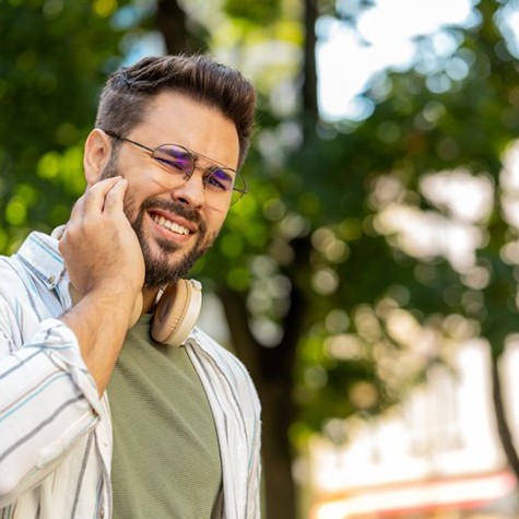Man grimacing due to dental pain