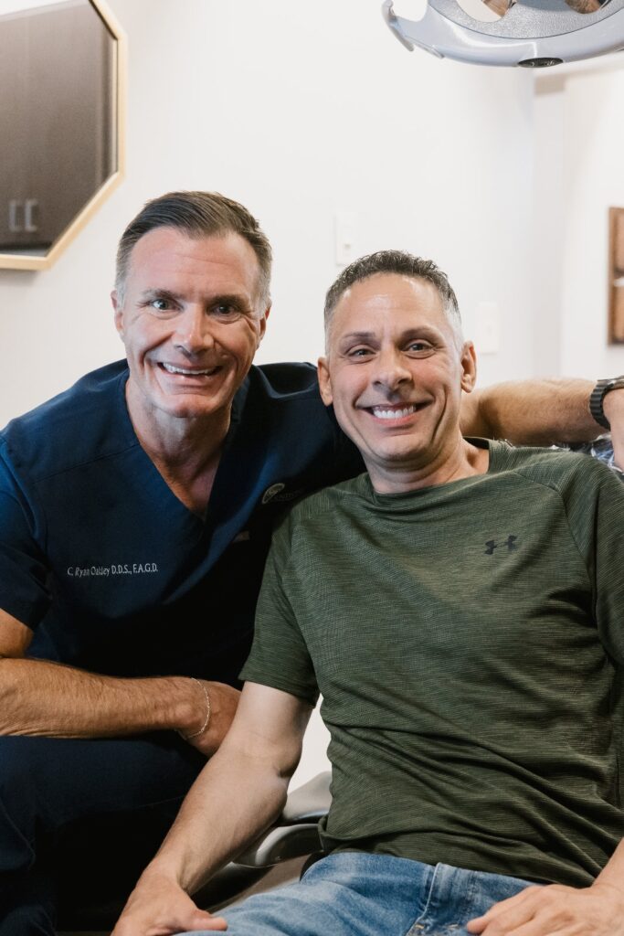 Landmark dentist with male patient smiling