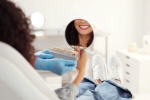 Cosmetic dentistry patient admiring her smile in mirror
