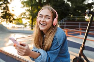 Happy, smiling teen girl wearing headphones 